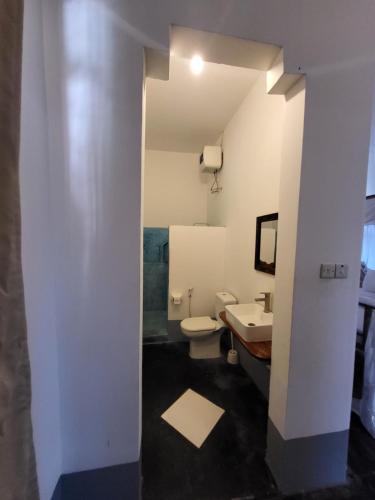 a bathroom with a toilet and a sink at Hiliki private house in Umbuji