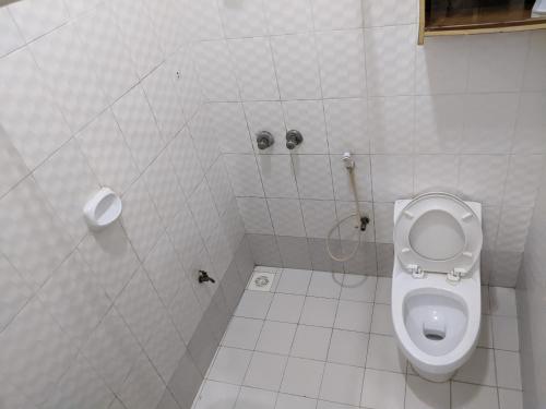 a bathroom with a toilet in a stall at Gs Villa Zanzibar in Zanzibar City