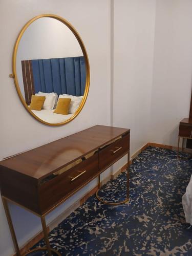 a dressing table with a mirror on a wall at Dorat Al Hafr - درة الحفر حفر الباطن in Hafr Al Baten