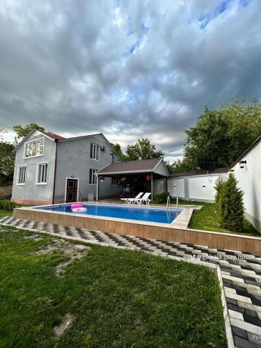 a house with a swimming pool in the yard at Peak Paradise Gabala Villa in Gabala
