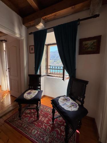 a living room with two chairs and a window at Waterfront Villa Magnolia in Kotor