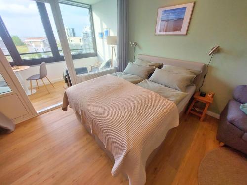 Ένα ή περισσότερα κρεβάτια σε δωμάτιο στο Apartment Hygge mit Ostseeblick