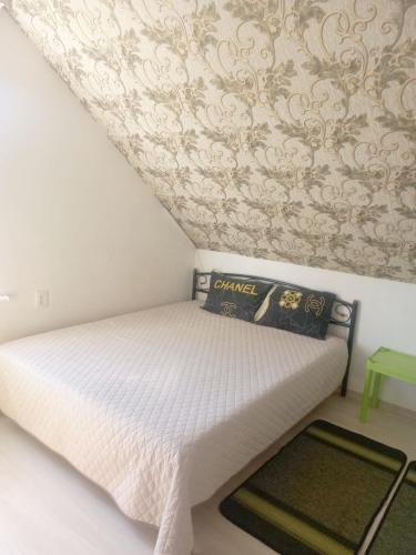 a small bedroom with a bed with a ceiling at Двухкомнатные апартаменты in Odesa