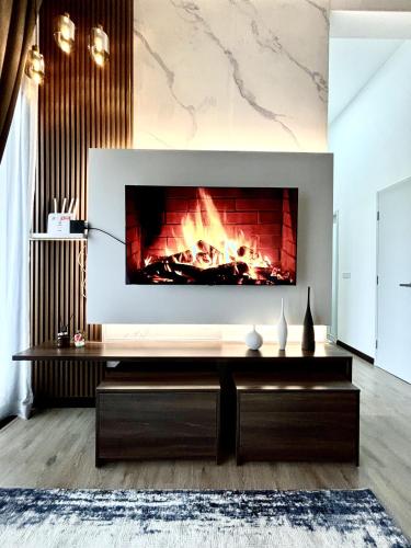 a fireplace in a living room with a fire place at ANNA AR ANTARA RESIDENCE LAKE VIEW, Putrajaya in Putrajaya