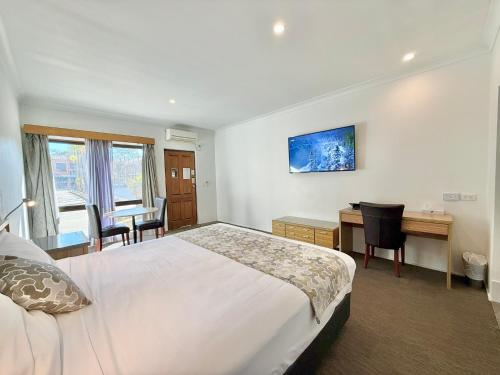 a hotel room with a bed and a desk and a desk at Albury Paddlesteamer in Albury