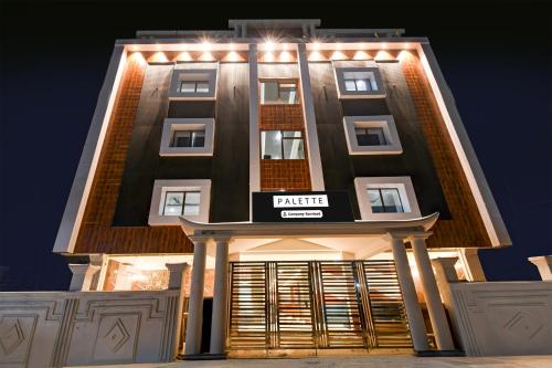 a building with a sign on the front of it at Palette Shree Jagannath Puri in Puri