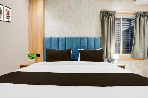 a bedroom with a large bed with a blue headboard at Super Collection O Manikarnika Sahi Near Jagannath Temple in Puri