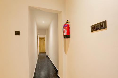 a hallway with a fire extinguisher on a wall at Super Collection O Manikarnika Sahi Near Jagannath Temple in Puri