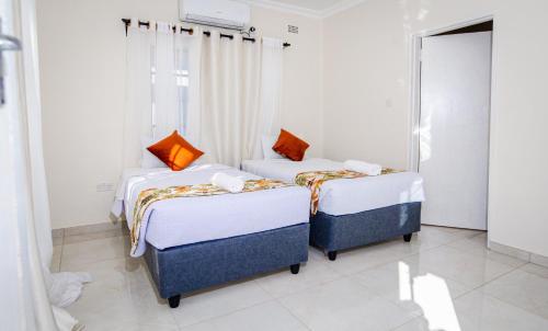 Postel nebo postele na pokoji v ubytování Grace Stays