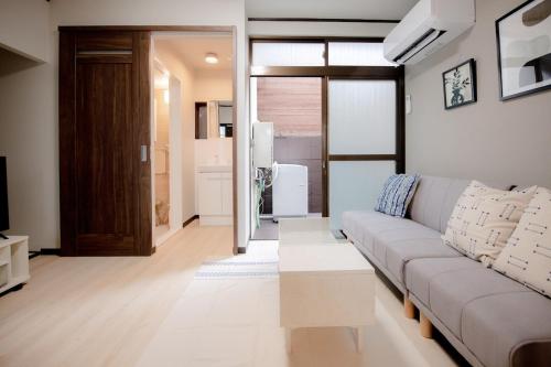 a living room with a couch and a table at GUAGUA house in Kyoto