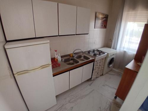 a small kitchen with a sink and a stove at bbsulmare-com in Porto Empedocle