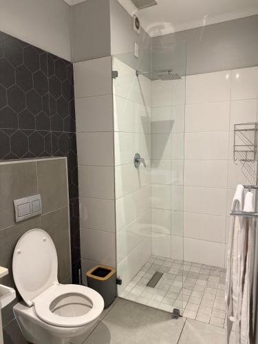 a bathroom with a toilet and a shower at 10 Bond Square in Durban