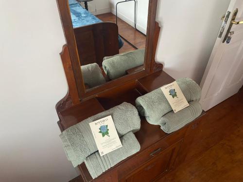 a mirror on a dresser with pillows in front at Botânico Guesthouse in Nordeste
