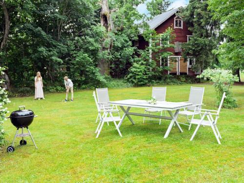 a grill and a table and chairs in a yard at 11 person holiday home in STORA SUNDBY in Böcklinge