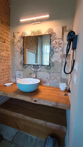 a bathroom with a sink and a mirror at Casa Levi in Bistagno