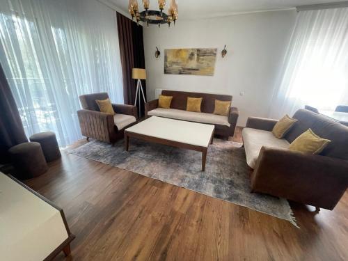 a living room with couches and a coffee table at Villa Mali in Ferizaj