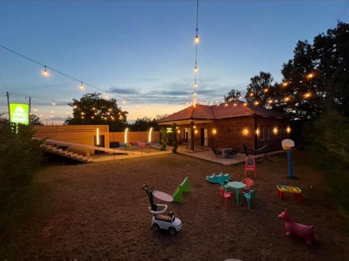 a backyard with a playground with toys and a house at Villa Mali in Ferizaj