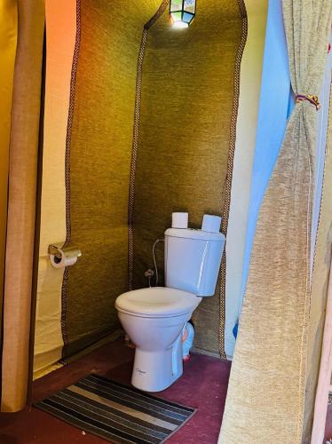 a bathroom with a toilet in a room at Starlight Erg Luxury Camp in Merzouga