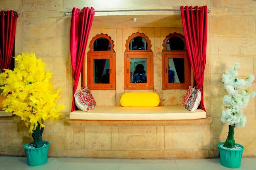 a lego house with a yellow bench and windows at Jaisalmer Haveli in Jaisalmer