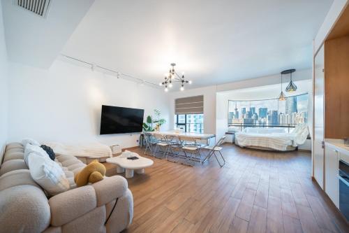 a living room with a couch and a table at ZHome - HaiQi Garden - Four Bedroom Apartment on the Bund with Bund View in Shanghai
