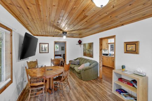 a living room with a table and a couch at Dog-Friendly Wine Country Cabin cabin in Cobb