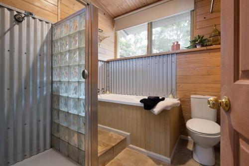 a bathroom with a toilet and a shower at Forest Estate Daylesford 8 Bedrooms 18 pax Pool Sauna Weddings in Glenlyon