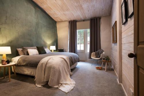 a bedroom with a large bed and a window at Forest Estate Daylesford 8 Bedrooms 18 pax Pool Sauna Weddings in Glenlyon