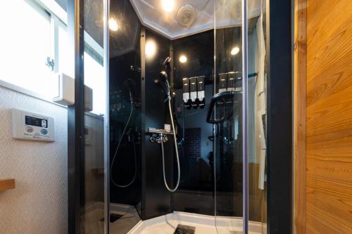 a shower in a bathroom with a glass shower stall at Joyful JUJO Stay 1minute walk from JR Jujo Station Shibuya 15min Shinjuku 11min Ikebukuro 6min Max 6guests 33square meters Simmons bed in Tokyo