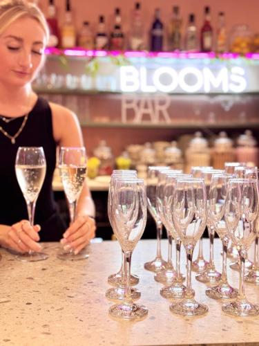 a woman sitting at a bar with a row of wine glasses at The Emsworth in Emsworth