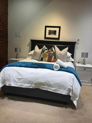 a bedroom with a large bed with stuffed animals on it at Rivonia Garden Suites in Johannesburg