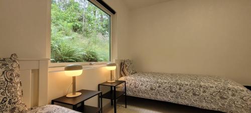 a bedroom with two beds and a window at Modern Full Comfort Villa in Agnesberg