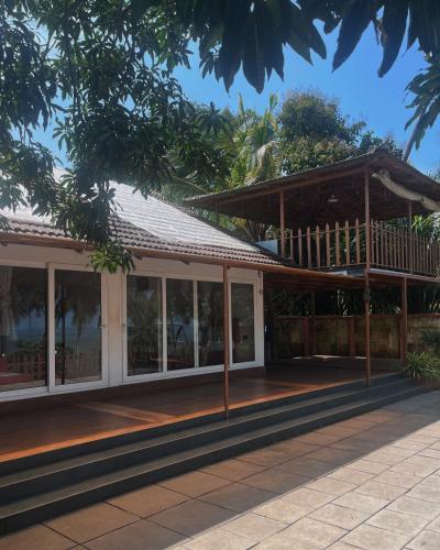 a house with a porch and a deck at Coastal Bay in Thottada
