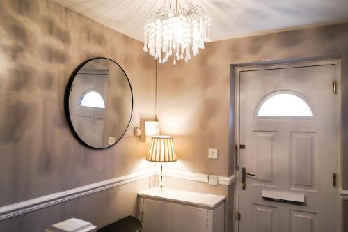 a bathroom with a mirror and a chandelier at The Townhouse Liverpool in Liverpool