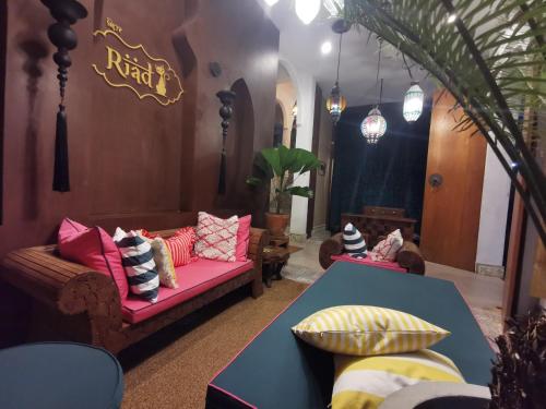 a living room with a couch and a table at Riad Hua Hin in Hua Hin