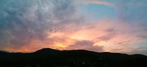 a sunset over the mountains with the sky at Napahong Treehouse นาป่าฮง Andromeda & Cassiopeia in Ban Pa Ha