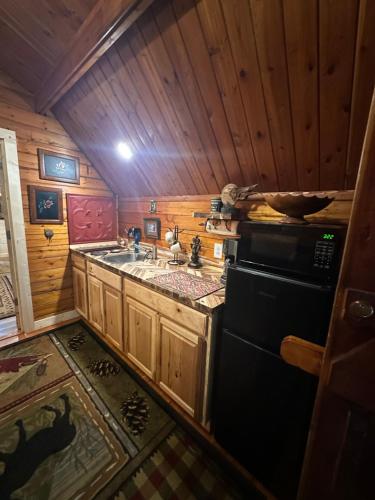a small kitchen with a sink and a stove at The Drake Cabin in The Forest in Cosby