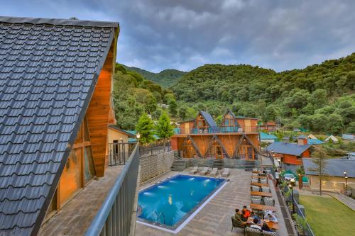 an aerial view of a house with a swimming pool at Dreamation Resorts in Bīr