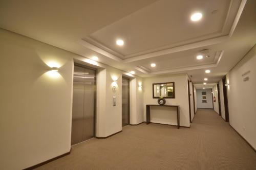 a hallway in a building with lights on the ceilings at Jinjiang Inn - Makati in Manila