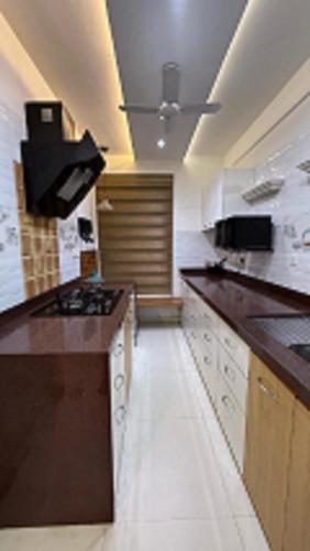 a large kitchen with a stove and a counter top at The Mannat Sanctuary in Lonavala