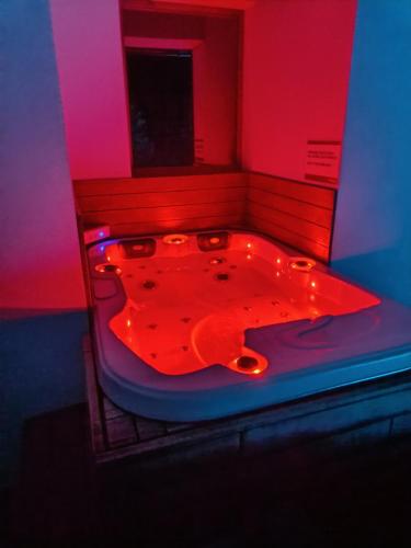 a red and blue bathroom with a red tub at Hiša Katja-Privat wellness in Kranjska Gora
