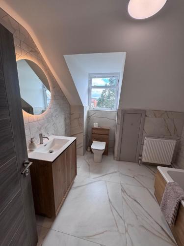 a bathroom with a sink and a toilet at Abhaille Chluaidh - Macaulay Letting in Helensburgh
