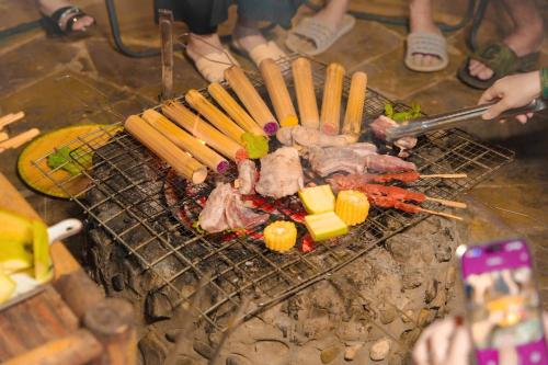 a grill with meat and other foods on it at Dó homestay in Sa Pa