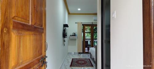 a hallway with a wooden door and a room at Abba's Glory Land - Agonda in Agonda