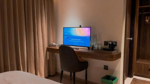 a computer monitor on a desk in a hotel room at FHotels in Bengaluru