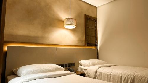 a room with two beds and a light at FHotels in Bengaluru