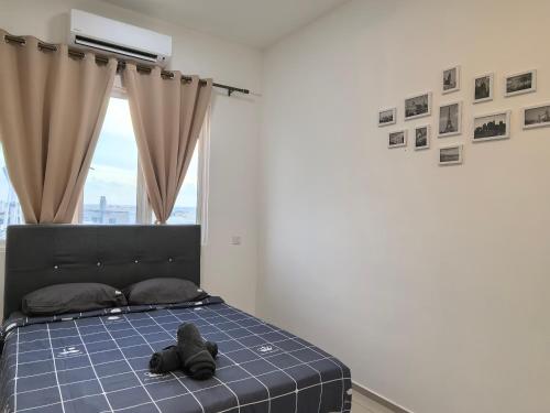 a bedroom with a bed with a stuffed animal on it at D Aman Infinity Pool Homestay 03 in Alor Setar