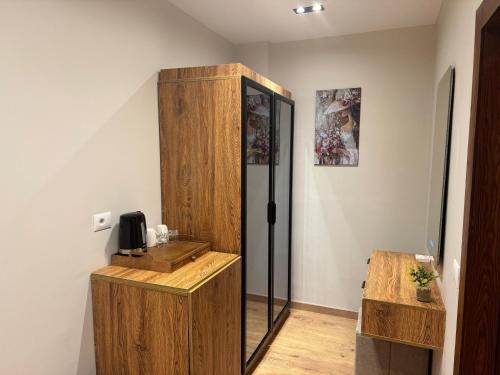 a room with a refrigerator and a wooden cabinet at Palacio Pyramids Hotel in Cairo