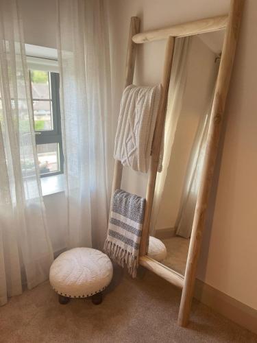 a room with a bunk bed with a stool and a mirror at 31 Lower English in Armagh