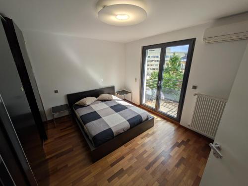 a bedroom with a bed and a large window at Topfloor Luxembourg Ville in Luxembourg