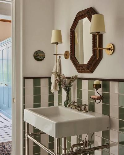 a bathroom with a white sink and a mirror at Artur house in Lubukbargalung